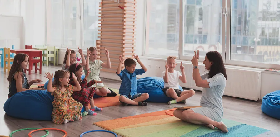 Educator leading a group activity with children in the Sullivan classroom.