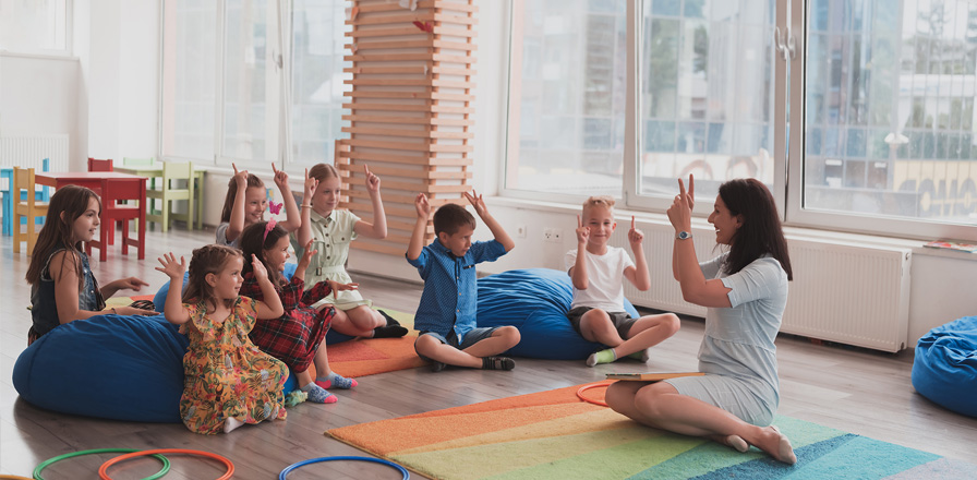 Educator leading a group activity with children in the Sullivan classroom.